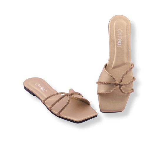 Pair of beige sandals with a bow detail on a white background