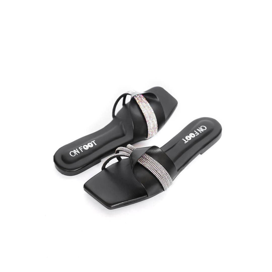 Black slides with rhinestone straps on a white background
