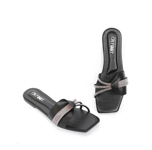 Black slides with rhinestone straps on a white background
