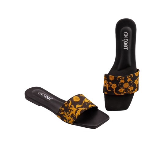 Black slides with yellow floral pattern on a white background
