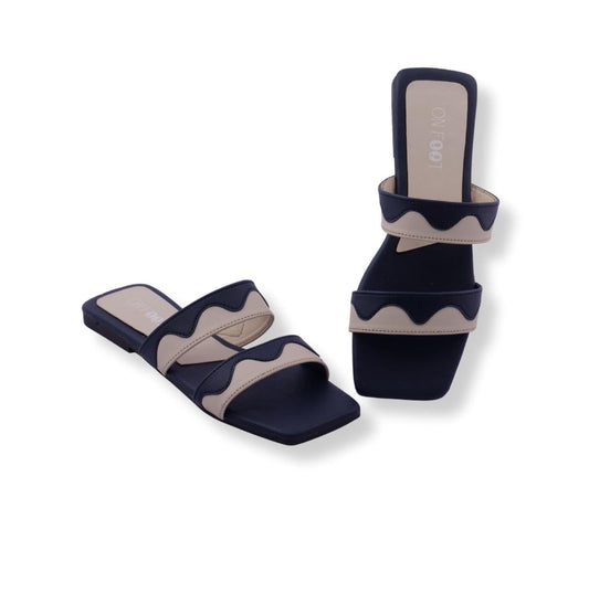 Navy and beige sandals on a white background