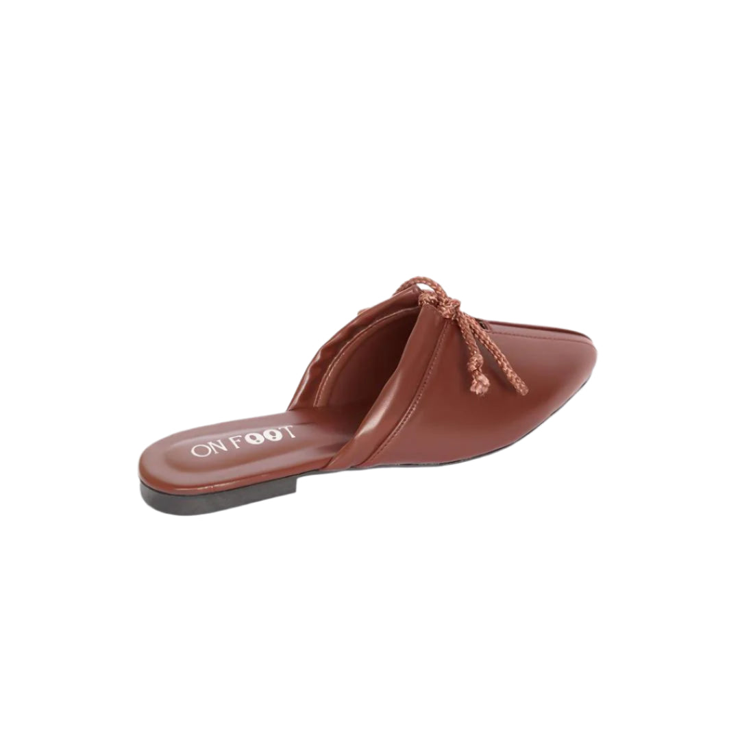 Brown slip-on shoe with a bow detail on a white background