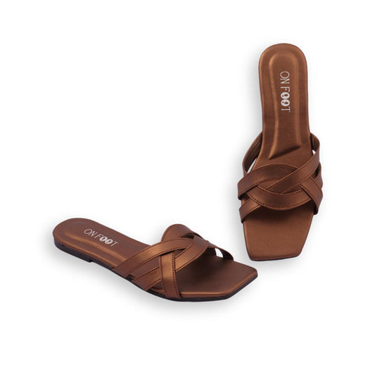 Brown sandals with criss-cross straps on a white background