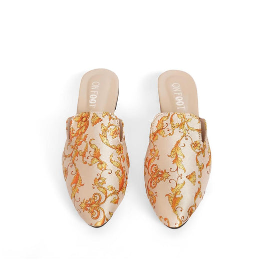 Pair of floral-patterned mules on a white background