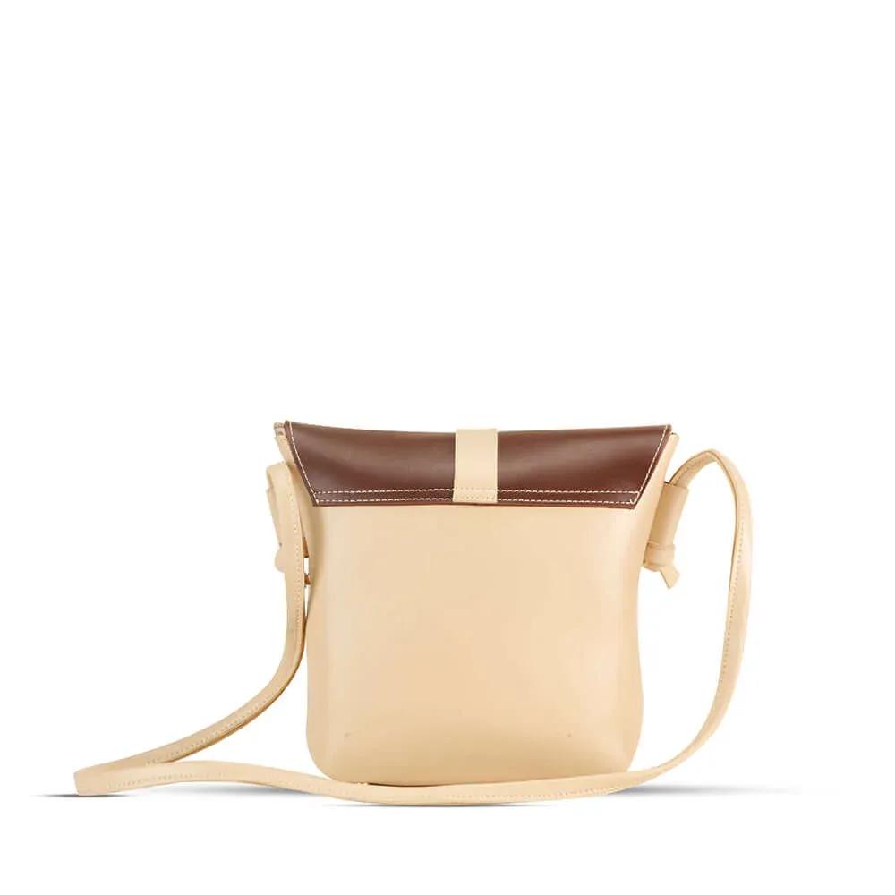 Beige crossbody bag with brown top section on a white background