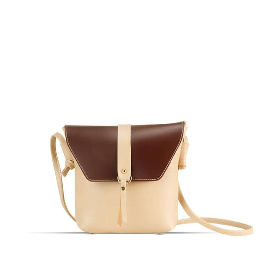 Two-tone beige and brown leather bag on a white background