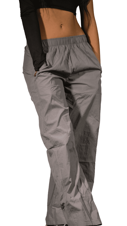Gray cargo pants worn by a lady on a white background