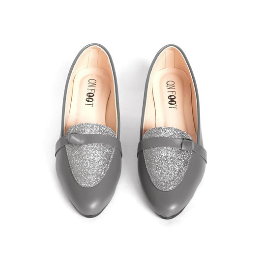 Pair of gray loafers with glittery soles on a white background