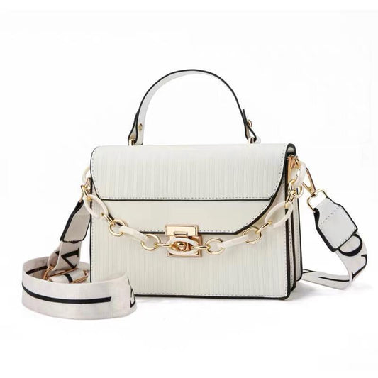 White handbag with gold chain strap on a white background
