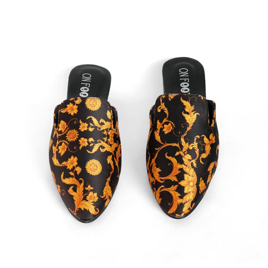 Pair of black and orange floral patterned shoes on a white background