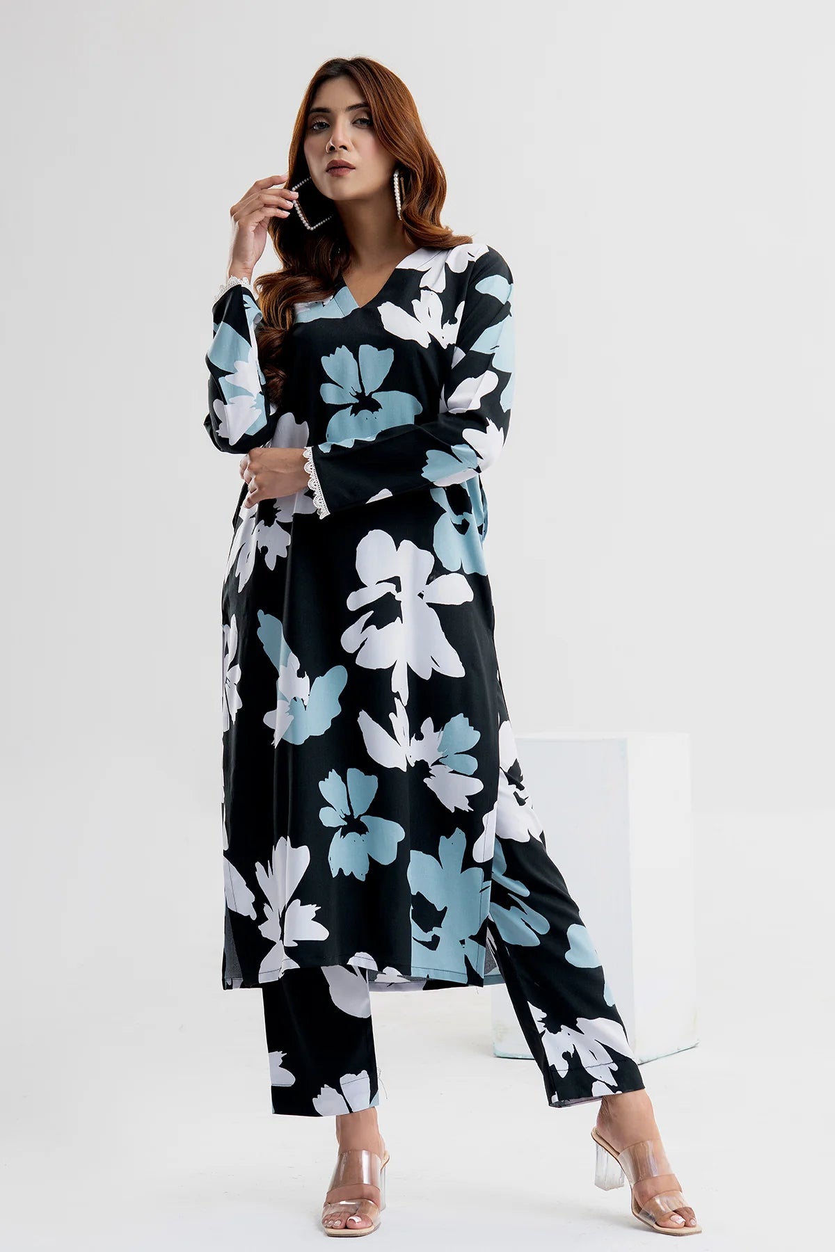 Woman wearing a black floral dress on a white background