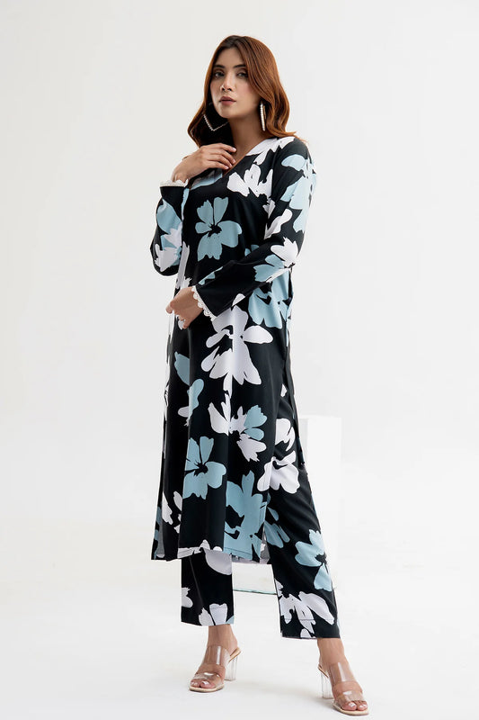 Woman wearing a black floral dress on a white background