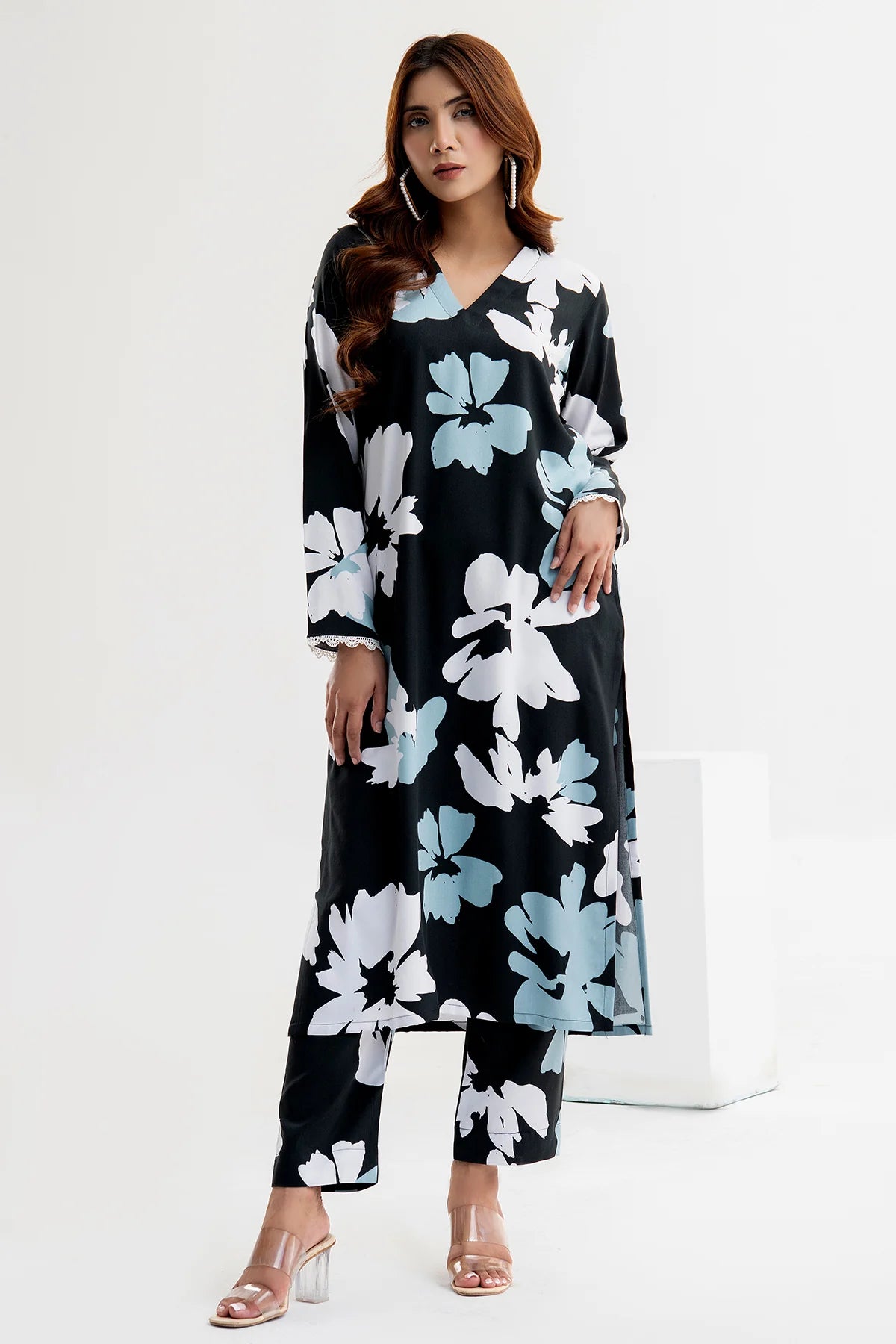 Woman wearing a black floral dress on a white background