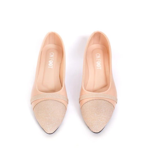 Pair of beige pointed-toe shoes with glittery accents on a white background