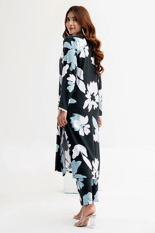 Woman wearing a black floral dress with blue flowers on a white background