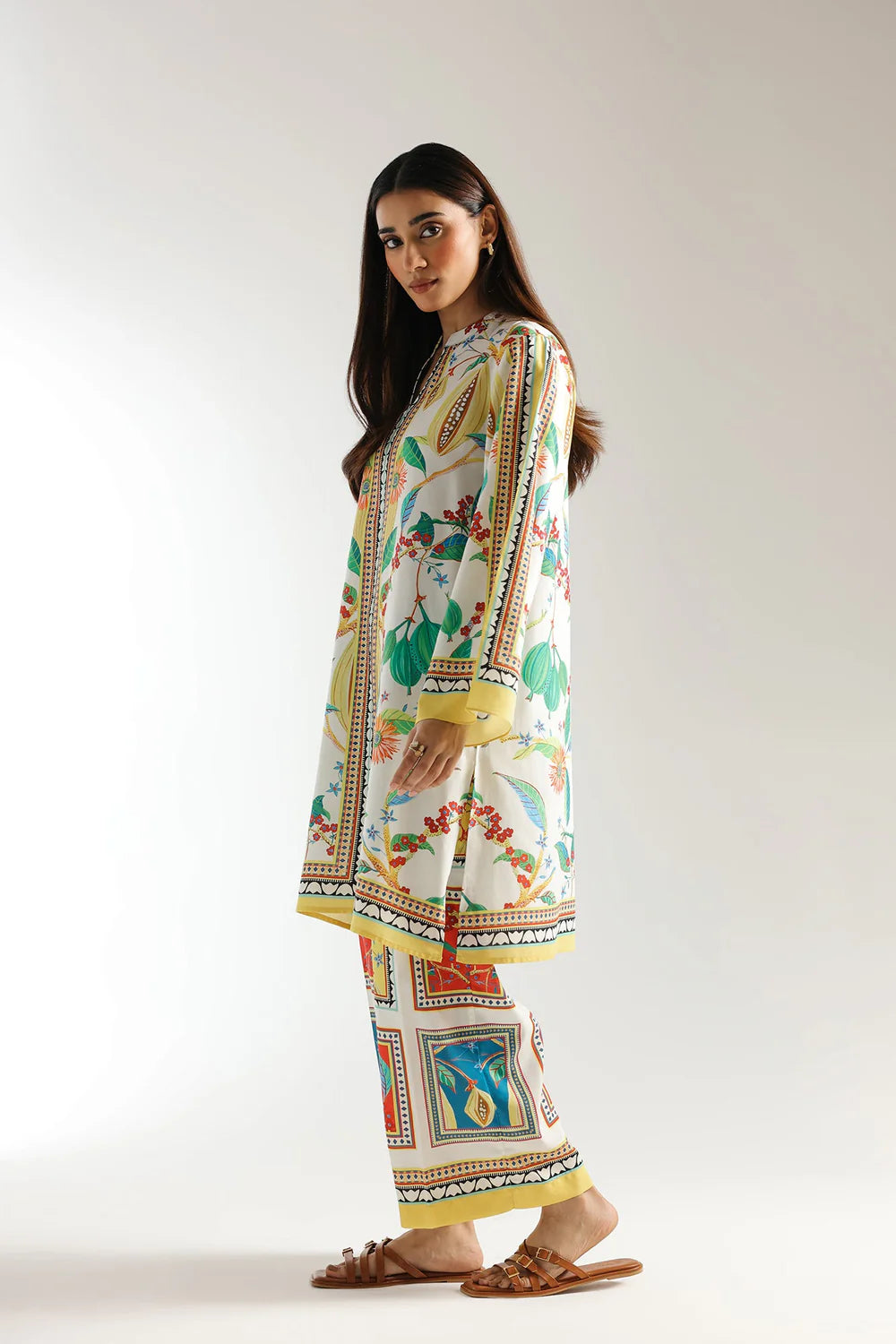 Woman wearing a colorful traditional outfit with a white background