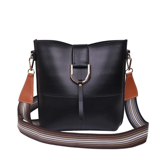 Black handbag with a brown and beige strap on a white background