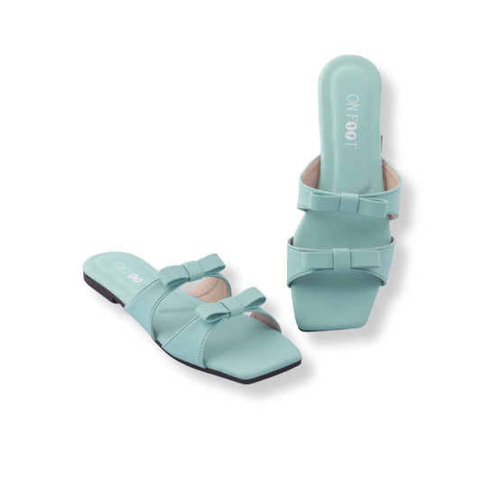 Pair of light blue sandals with a bow on a white background