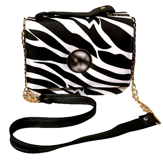 Zebra print handbag with a pearl-like button on a white background