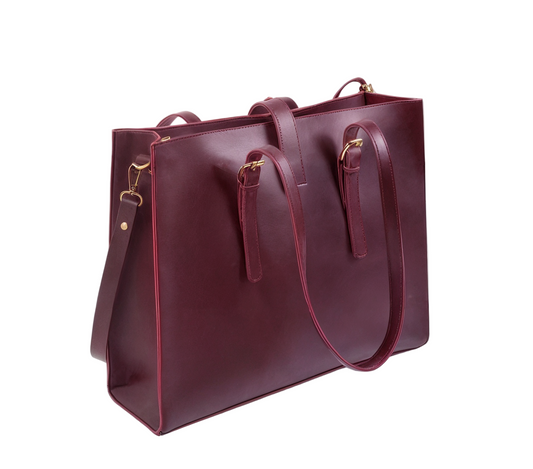 Maroon handbag with gold hardware on a white background