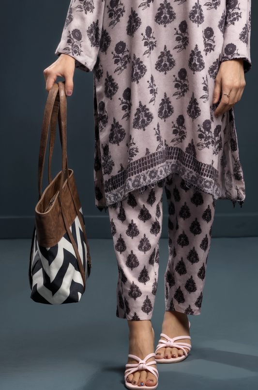 Lady wearing a patterned outfit holding a Chevron pattern tote bag with tan PU leather and long handles against a gray background