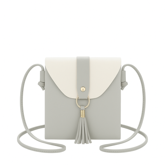 Gray and white crossbody bag with a tassel on a white background