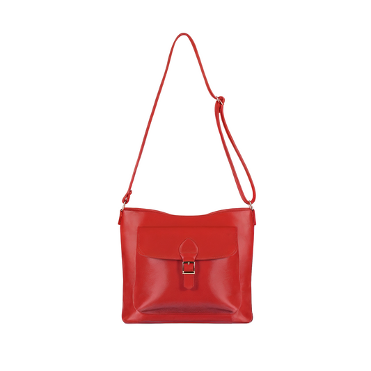 Red leather handbag with a strap on a white background