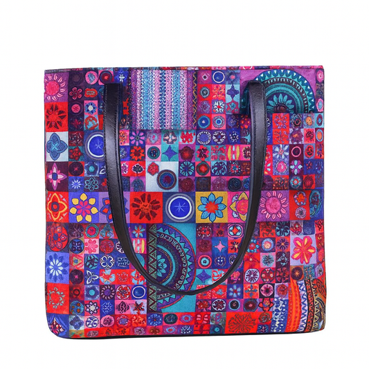 Colorful patterned tote bag with black handles on a white background