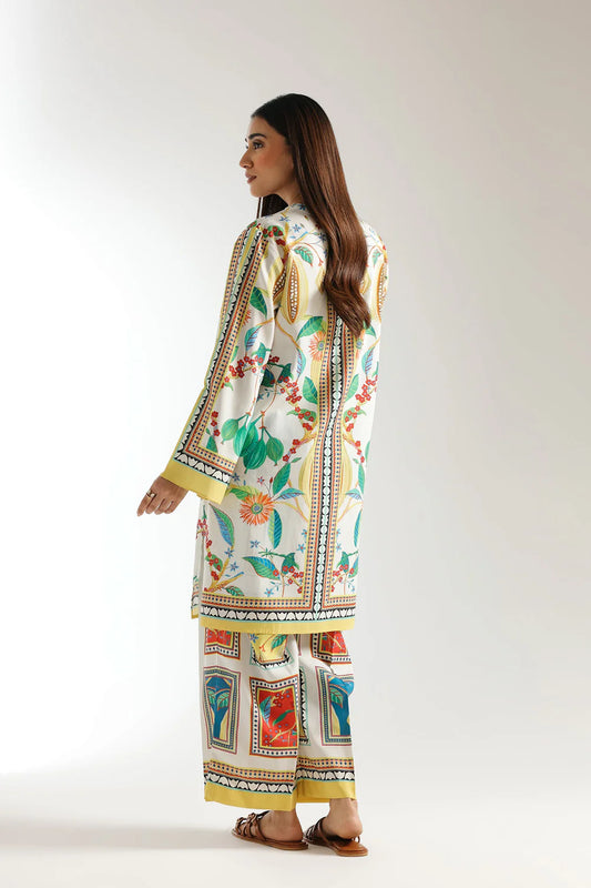 Woman wearing a colorful patterned dress on a white background