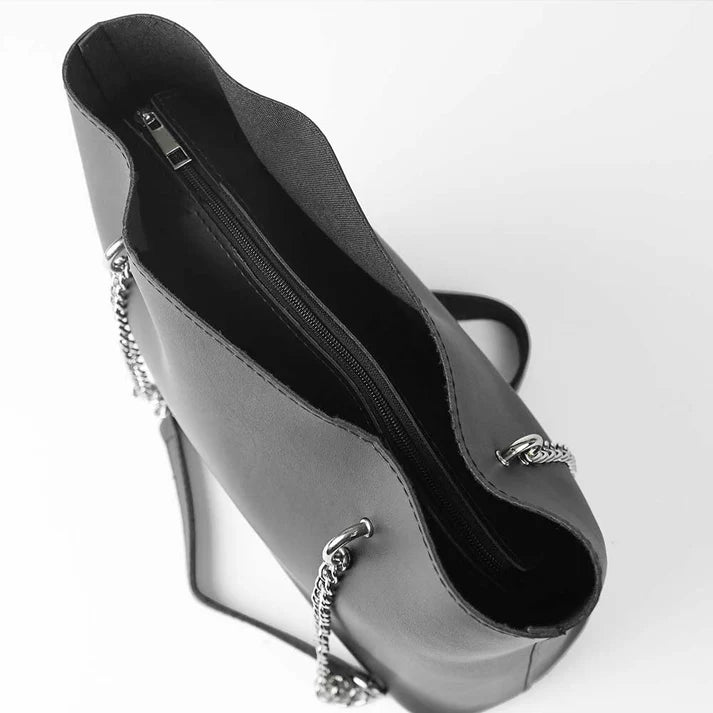 black tote hand bag with chain details on a white background