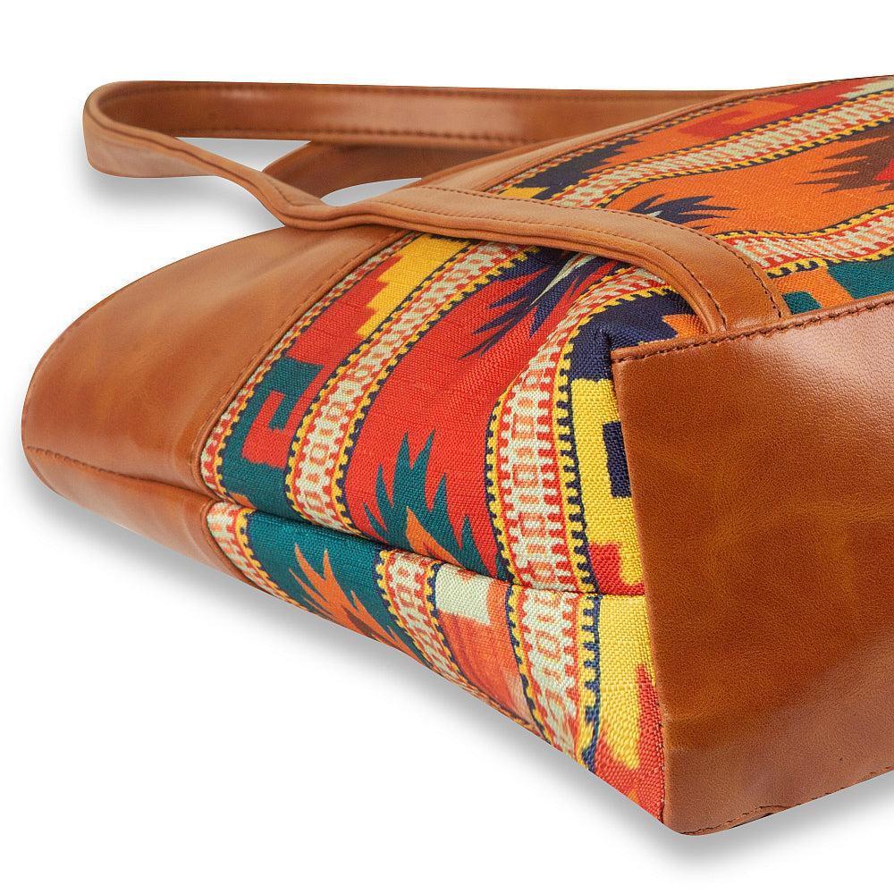 Brown leather bag with colorful patterned lining on a white background