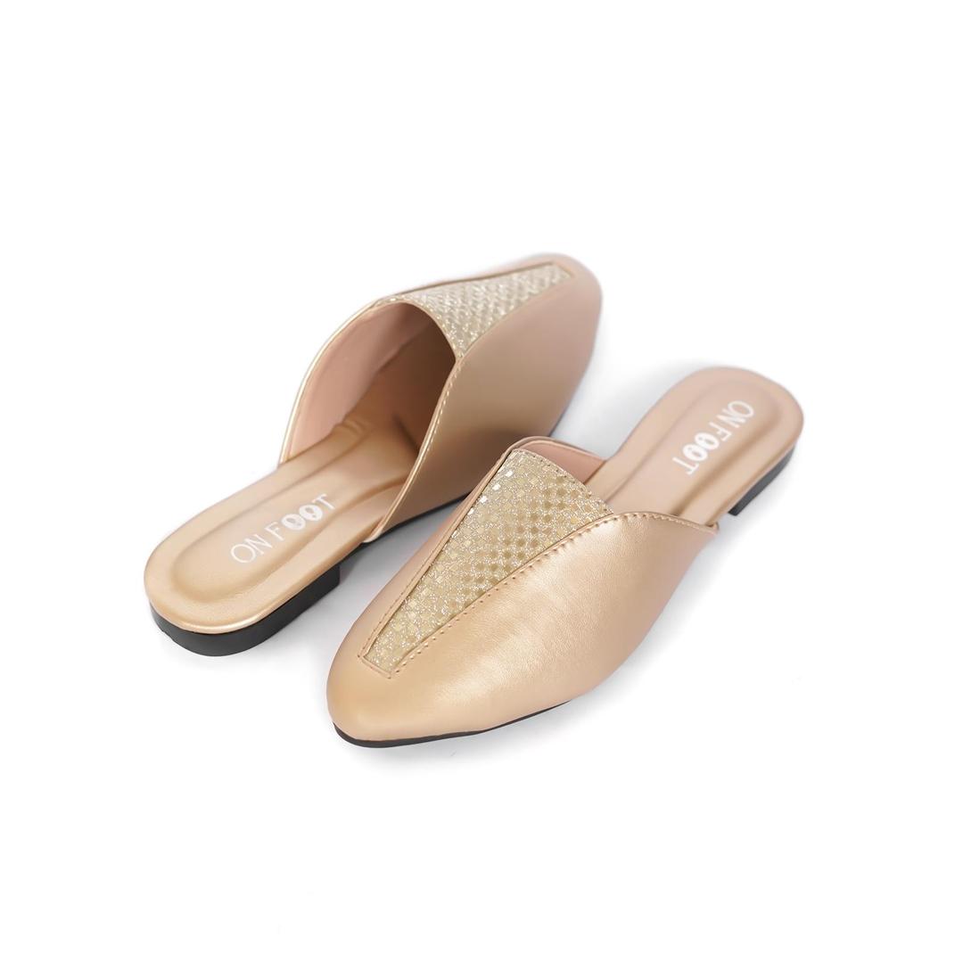 Pair of beige mules with a textured pattern on a white background
