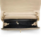 Beige handbag with gold hardware on a white background