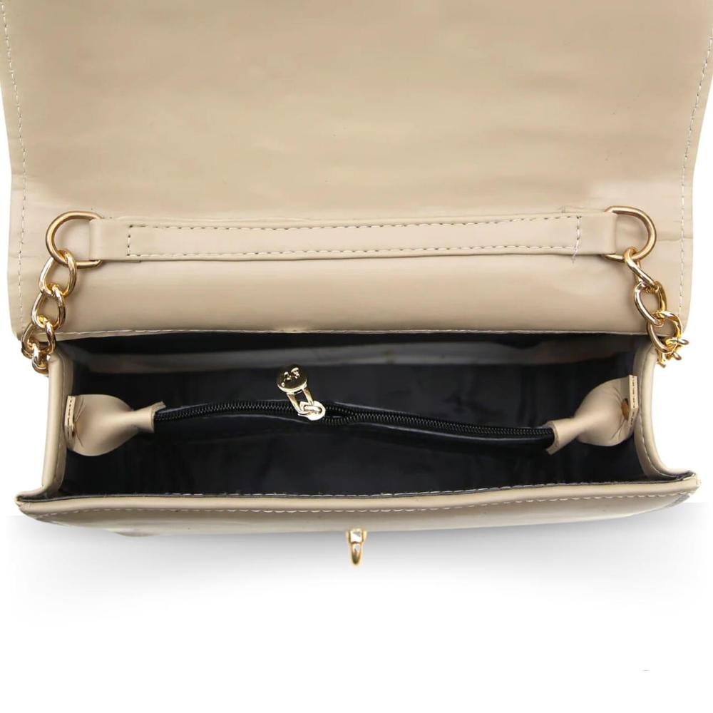 Beige handbag with gold hardware on a white background