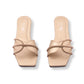 Pair of beige sandals with brown straps on a white background