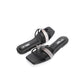 Black slides with rhinestone straps on a white background