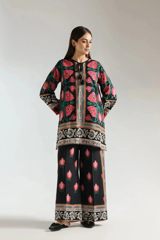 Woman wearing a traditional outfit with floral patterns on a plain background
