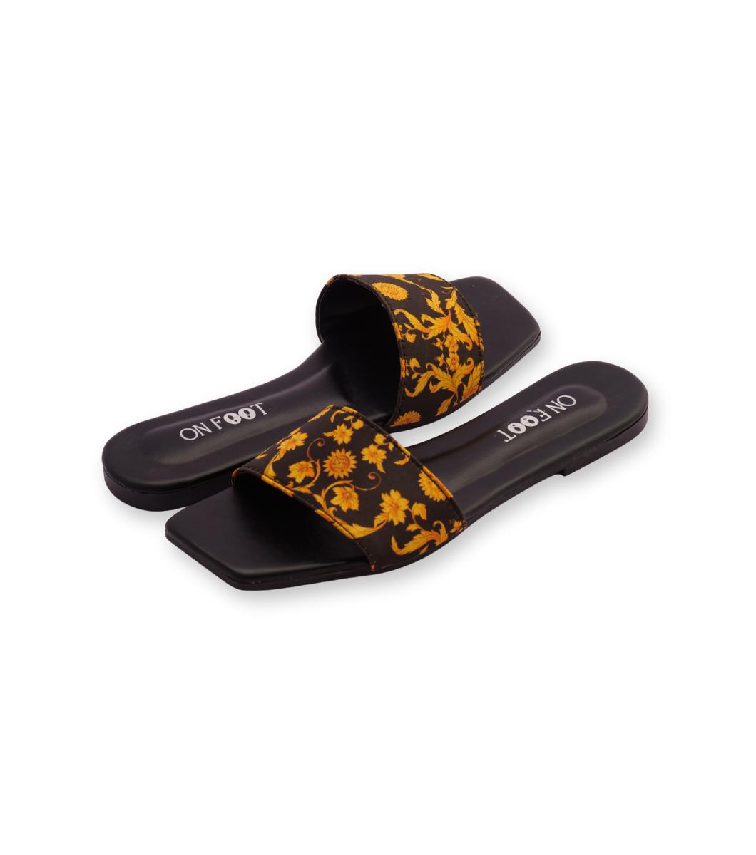 Black slides with yellow floral pattern on a white background
