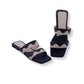 Navy and beige sandals on a white background
