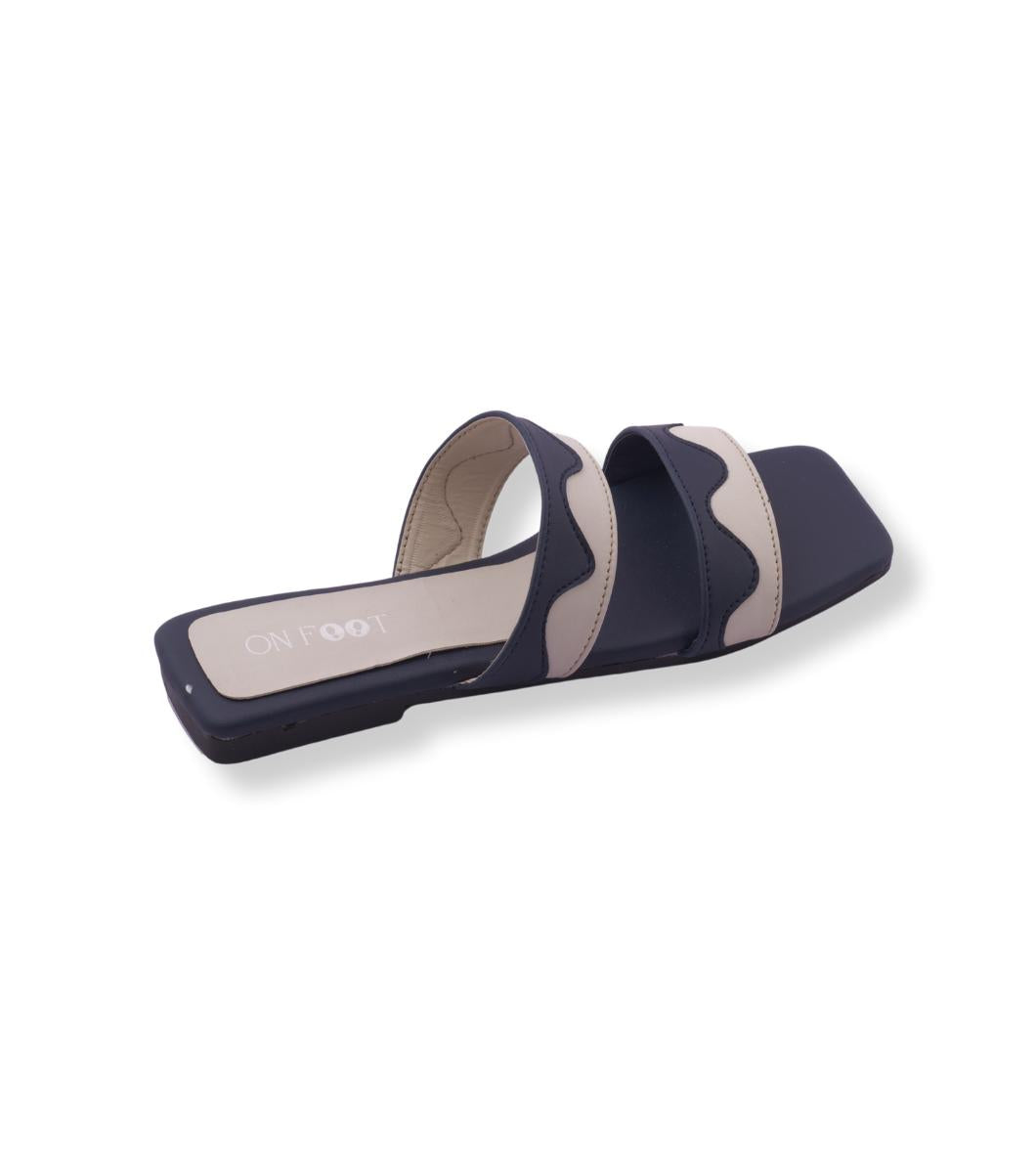 Navy and beige slide sandal on a white background