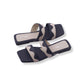 Pair of navy and beige slide sandals on a white background