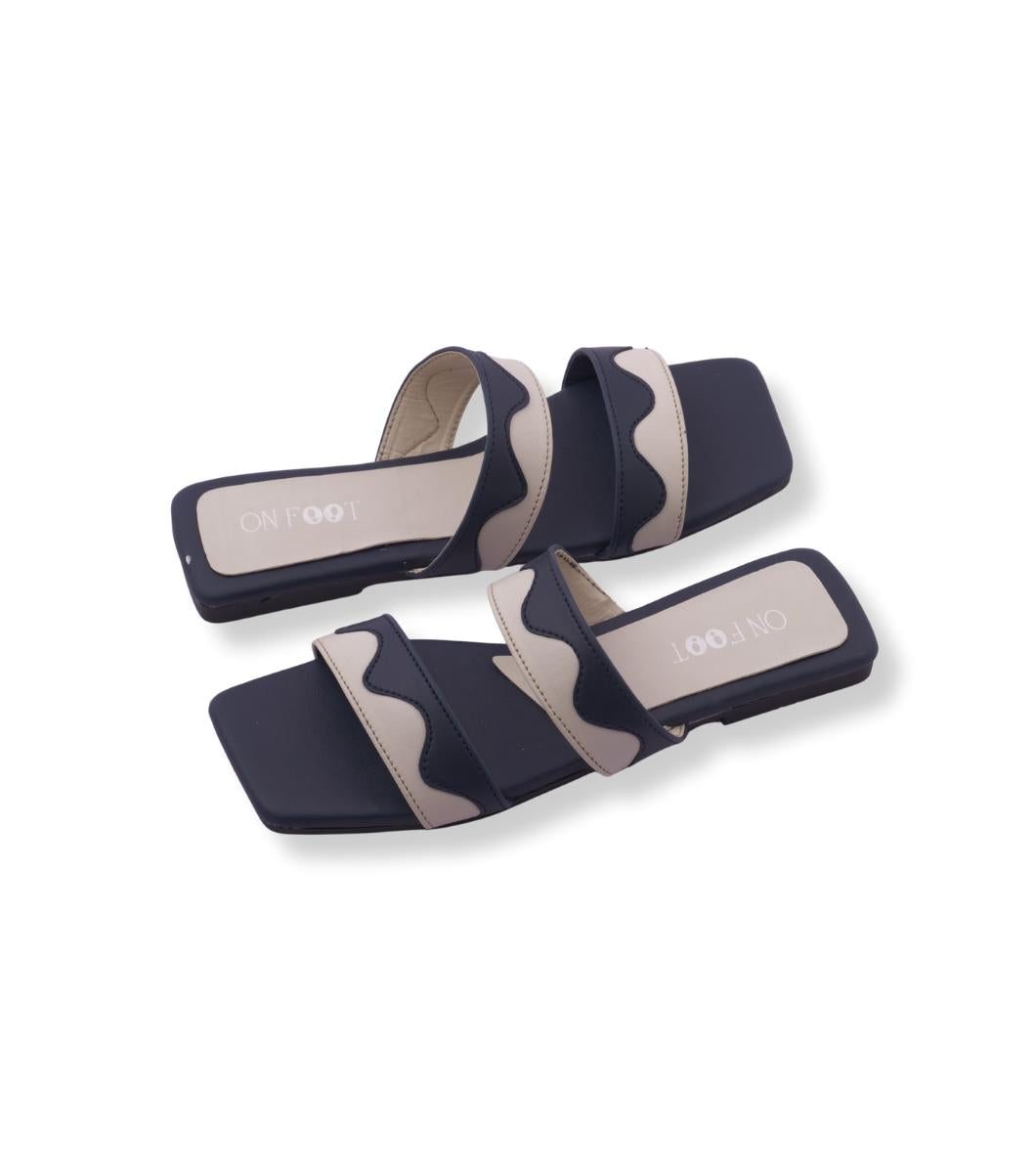 Pair of navy and beige slide sandals on a white background