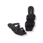 Black sandals with a bow design on a white background