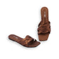 Brown sandals with criss-cross straps on a white background