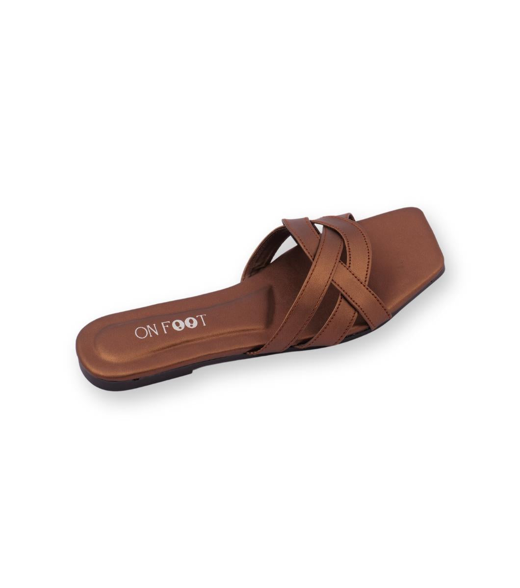Brown sandal with criss-cross straps on a white background