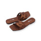 Pair of brown sandals with 'On Foot' branding on a white background