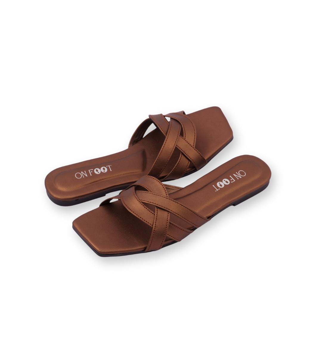 Pair of brown sandals with 'On Foot' branding on a white background