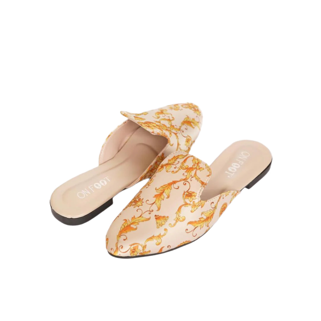Pair of floral-patterned mules on a white background