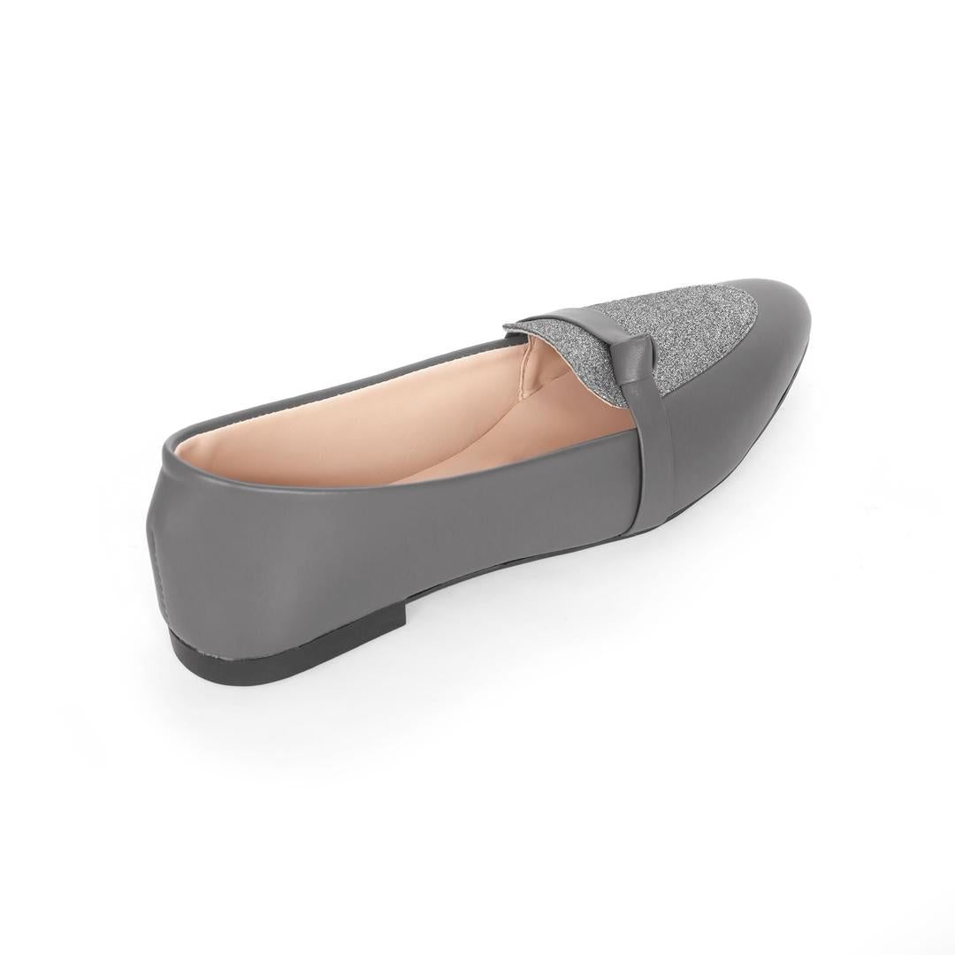 Gray flat shoe with a textured toe cap on a white background