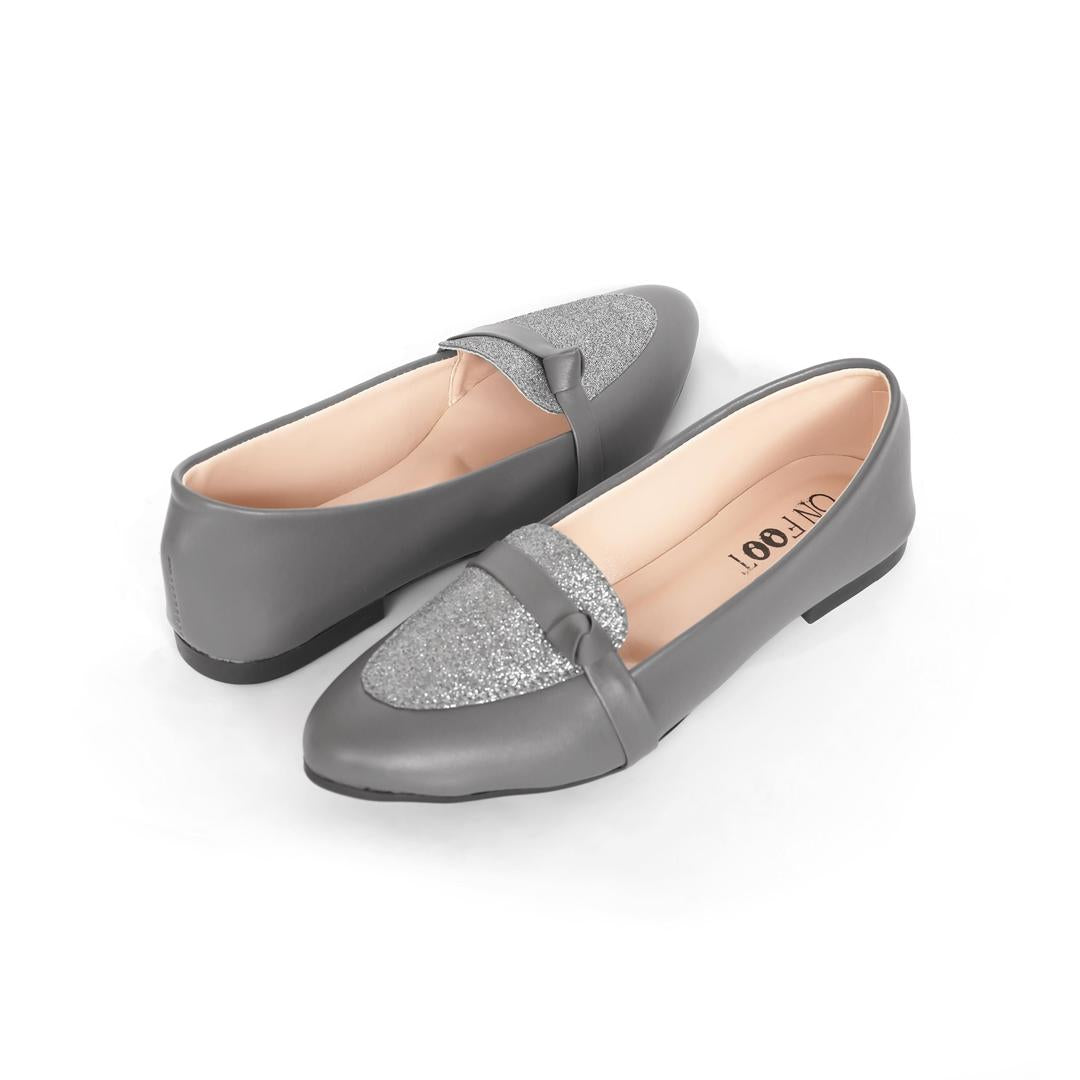 Pair of gray loafers with glittery bow on a white background
